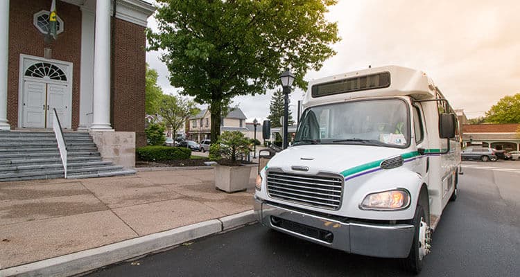 Westmoreland Transit bus stopped at a courthouse.