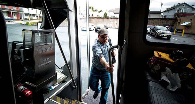 Passenger boarding a Westmoreland Transit bus.