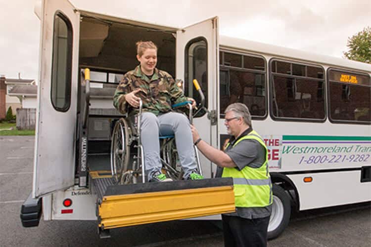Happy passenger disembarking a Westmoreland Transit bus.