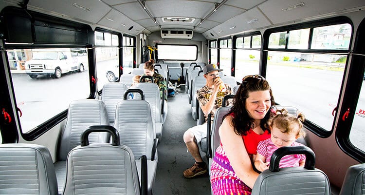 Happy people riding a Westmoreland Transit bus.