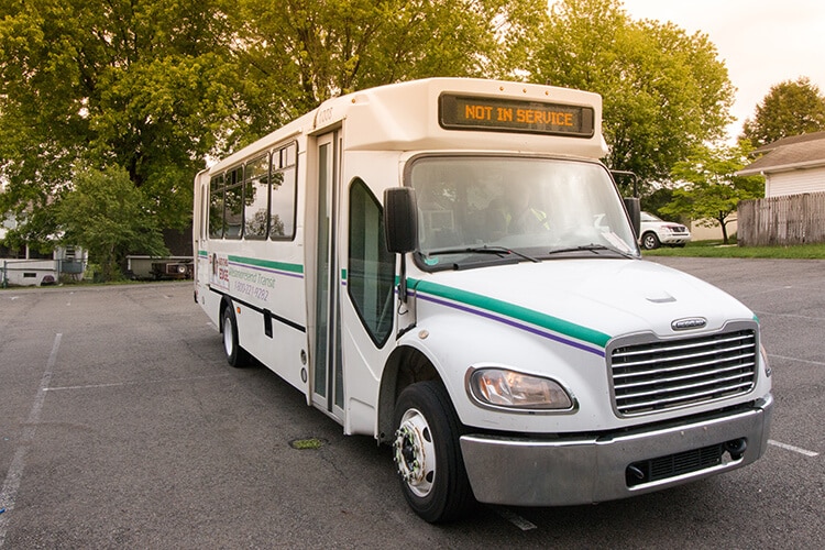 Westmoreland Transit bus in a parking lot with trees in the background.