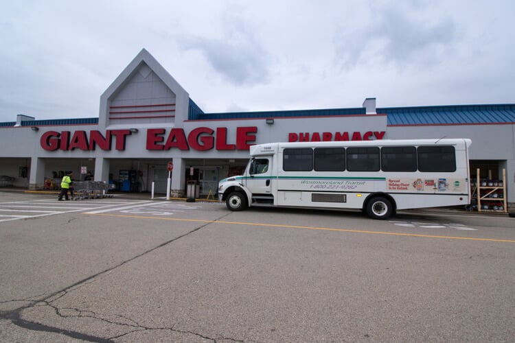 Westmoreland Transit bus stopped at a Giant Eagle grocery store.